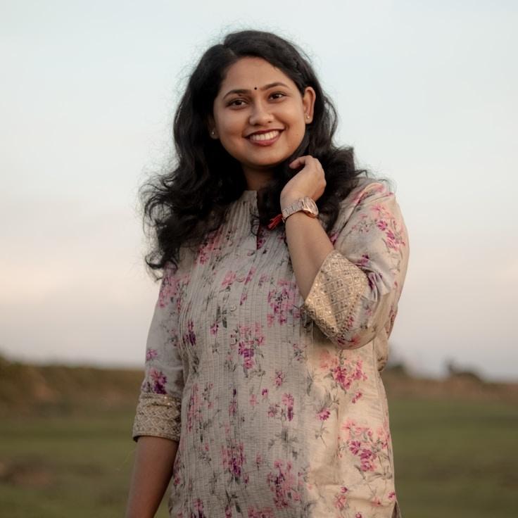 Kaveri Mehta, Lead Design Curator at Forest Anchor Craft, reviewing corporate floral arrangements